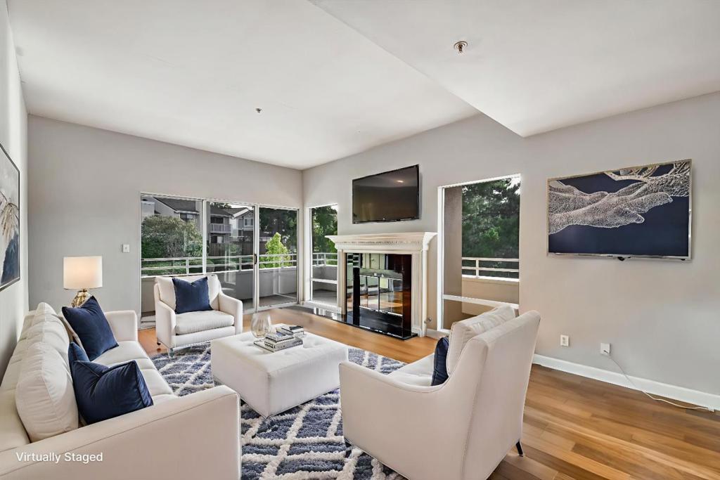 Top-floor end unit with a wraparound balcony offering views of De Anza Blvd and peeks of the bay. This light-filled home features wood flooring, a cozy gas fireplace, and an updated kitchen with granite countertops, stainless steel appliances, a wine fridge, and stylish cabinetry. The bathrooms have been tastefully renovated, and in-unit laundry adds everyday convenience. Includes two assigned parking spaces, one in the secured garage and one in the adjacent lot, PLUS a dedicated storage unit. The community offers a pool, spa, cabana, and a rare guest suite for visiting family or friends. Ideally located with easy access to Highways 92, 280, and 101, as well as nearby shopping, dining, and parks, this condo blends comfort, privacy, and convenience.