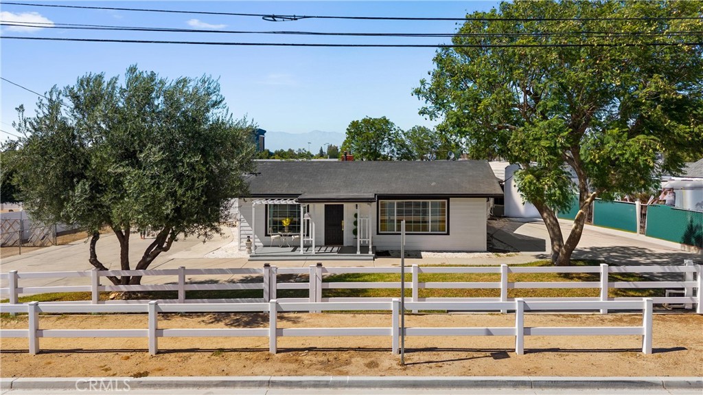 Welcome to Horse Town USA!
This beautifully maintained, turnkey home is ideally located in the heart of Norco—just minutes from the 15 and 91 freeways, and within walking distance to schools and all the amenities that make this unique equestrian community so desirable. The home features two spacious bedrooms and a large ensuite, complemented by brand-new flooring and fresh paint throughout. The front yard is fully enclosed with a new vinyl fence and automatic gates, offering both security and convenience. Step inside to find a generously sized laundry room with a full bathroom and direct access to the backyard—ideal for cleanup after a day of riding or working outdoors. The fully usable 20,000 sq ft lot offers endless possibilities, with plenty of space for animals, trailers, RVs, toys, or future expansion. Out back, enjoy a mini orchard, a spacious storage shed, and ample covered RV parking. The property also features a freshly painted carport that accommodates two additional vehicles, and a brand-new garage door on the attached two-car garage for added curb appeal. Live the true Norco lifestyle with arenas and parks scattered throughout the city, and enjoy close proximity to the 80-acre George Ingalls Equestrian Event Center and the scenic Hidden Valley Wildlife Preserve. Don't miss your chance to own a slice of the Norco dream—schedule your private showing today!