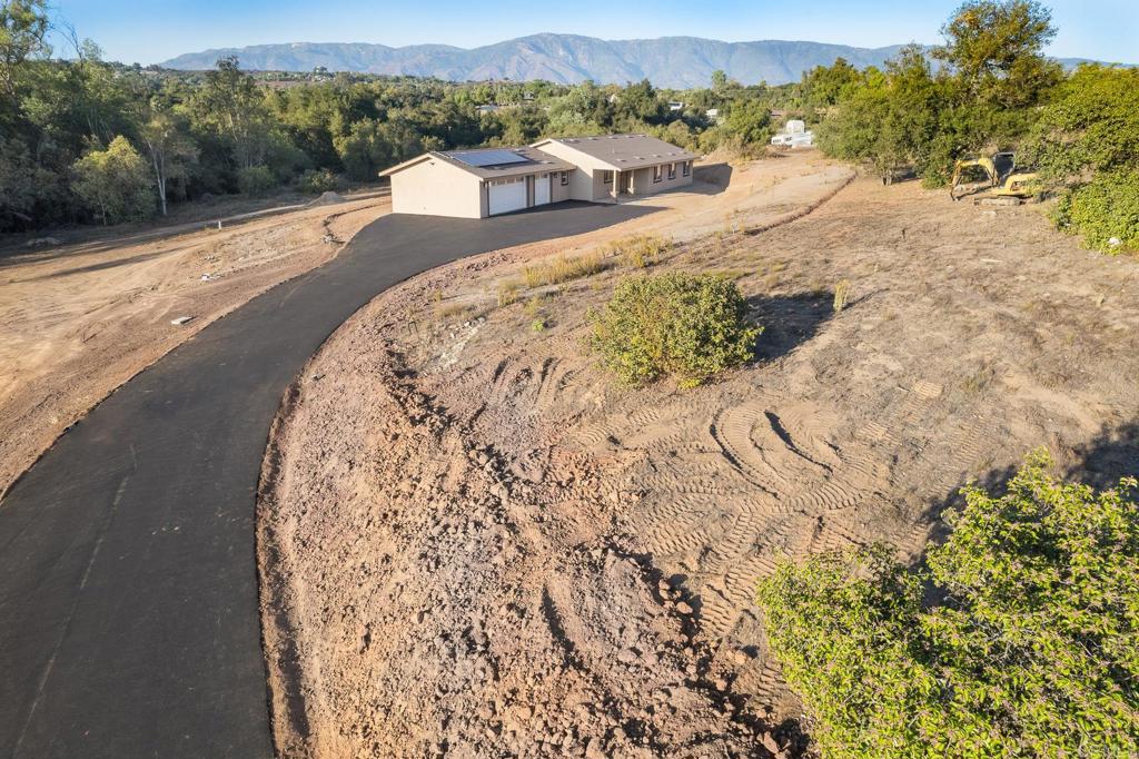 Brand New 2025 Construction – Single-Story Craftsman on 2.42 Acres! This beautiful home is ready, complete with a brand new driveway. Located on a spacious useable lot. This 2,080 sq. ft. home offers 4 bedrooms (or 3 + office), 2.5 bathrooms and a 3-car garage, along with a pad for a future ADU or Workshop. Interior Highlights: Open Layout, Wide hallways, vaulted ceilings, recessed lighting, 5” baseboards, lots of windows that create a bright and airy atmosphere. Gourmet Kitchen: Stunning 4x8 solid granite slab island with storage on both sides, walk-in pantry with glass door and modern finishes throughout including a pot filler. Owner’s Suite: Includes a barn door entry to private bath, spacious layout, dual sinks, and a frameless 3/8" glass shower enclosure plus a soaking tub and walk in closet. Technology Ready: CAT 6 wiring in all rooms, RG6 TV Cable, fire sprinklers, whole-house fan, and startup solar system. Functional Laundry: Propane and electric dryer hookups, tankless water heater, and extra linen cabinetry for ample storage. Exterior & Lot Features: Slider access to a concrete back patio—perfect for gatherings and outdoor living. RV cleanout, and a 50-amp hookup in the garage. Quality Build: 5” Fire X drywall, double paper shingle roof, 1,500-gallon septic system, and a 42" solid knotty alder front door with rivet accents and peephole. Parking & Storage: Room for RVs, utility vehicles, trailers, and more. Don’t miss this opportunity to own a brand-new home with modern upgrades, thoughtful design, and room to grow. Schedule your private showing today.
