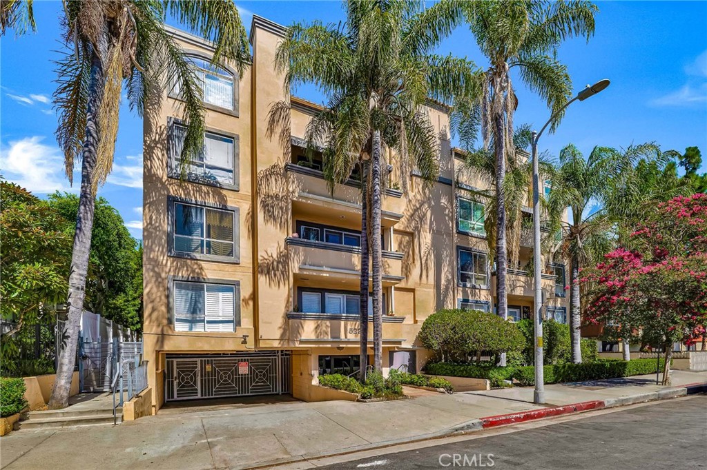 This rare rear corner unit in the coveted San Tropez West Villas of Encino is a gorgeous oasis & combines privacy, pristine panoramic east-facing views & refined interior features across 2 en-suite bedrooms, 2.5 baths, & 1,538 sq ft of luxurious living space. Unlike many other units w/ balconies facing neighboring bldgs, this home boasts a spacious balcony w/ sweeping, sunrise views that flood the interior w/ beautiful natural light. Large windows w/ new plantation shutters & recessed lighting are featured throughout, enhancing the bright, airy ambiance. Double-door entry opens to an elegant foyer w/ tray ceiling & chic chandelier, leading into a bright, open-concept living & dining area. Living room offers a corner fireplace, wet bar, & French doors to the private view balcony. Adjoining dining space features a 2nd tray ceiling w/ elegant chandelier, & mirrored accent wall amplifying the natural light & creating a sense of even more grandeur. Kitchen opens to the dining area via a breakfast bar & features white cabinetry, granite countertops, tumbled marble backsplash, & newly upgraded stainless-steel appliances, including a gas cooktop, microwave, double convection oven, & dishwasher. A hallway off the kitchen leads to a dedicated laundry area w/ spacious pantry & storage closet & circles back to the foyer w/ an elegant powder bath convenient for guests. Both spacious bedrooms are privately positioned at the back of the unit w/ stunning views. Oversized primary suite includes its own fireplace, walk-in closet, & a luxurious en-suite bath w/ dual-sink vanity, jetted soaking tub, & separate shower. Secondary suite offers mirrored closet doors & ¾ en-suite bath. 2-car tandem parking in a secure subterranean garage & access to resort-style amenities such as an inground pool & spa, fitness center w/ sauna, secure building entry, & elevator access. HOA dues cover water, trash, basic cable, & earthquake insurance. Perfectly situated just moments from trendy Ventura Boulevard, this home offers easy access to vibrant dining & shopping—including spots like Esso Mediterranean Bistro, Vino Wine & Tapas Room, Coral Tree Café, Trader Joe’s, Gelson’s & Target—as well as nearby recreation like the Sepulveda Basin Recreation Area, Balboa Golf Course, & Los Encinos State Historic Park. Commuters will appreciate proximity to the 101 & 405 freeways, & families benefit from access to highly rated schools such as Nestle Avenue Charter Elementary & Portola Middle School.
