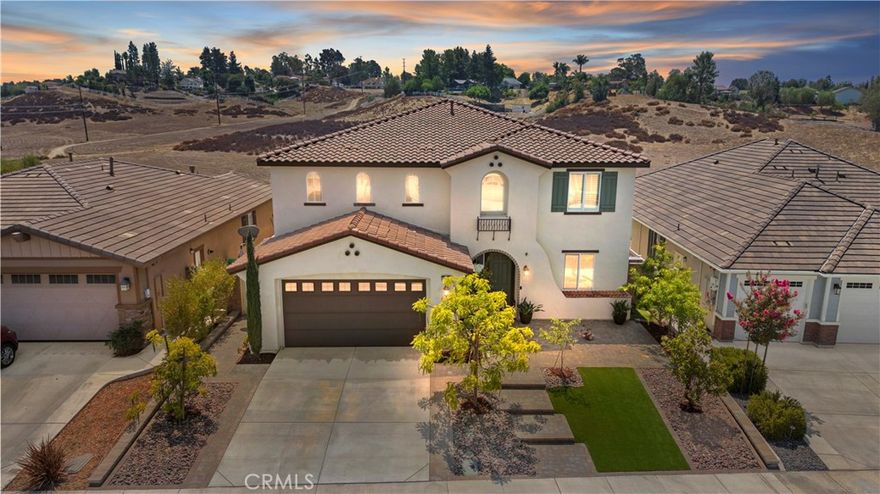 Welcome to this stunning home located in the highly desirable gated community of Nicolas Heights—a small, private enclave in the heart of Temecula offering both privacy and peace of mind. Built in 2019, this 3,648 sq ft residence showcases a sleek, modern layout and exceptional designer upgrades throughout, all set on a premium view lot with no rear neighbors and panoramic scenery that enhances everyday living. The curb appeal is undeniable, with wrought iron accents and fully finished front and back yards featuring eye-catching brick pavers and lush landscaping. Inside, you'll find a light-filled open floor plan with elegant tile and wood flooring, plantation shutters, and brand new interior paint that gives the home a fresh, updated finish. The inviting kitchen is a showstopper, boasting a large quartz island, detailed stone backsplash, pendant lighting, GE Profile stainless steel appliances, a 5-burner stove, double oven, walk-in pantry, and Samsung refrigerator that stays. A butler’s pantry adds extra storage and convenience for hosting. The open-concept family room includes a custom fireplace, and a downstairs bedroom with full bath provides ideal flexibility for guests or multi-generational living. Wrought iron staircase railings lead to the second floor, where a spacious upstairs loft-style second living area offers plenty of room to relax, entertain, or create your ideal flex space. Three additional upstairs bedrooms are generously sized, and the secondary bathroom feature modern styling. The luxurious primary suite includes a large walk-in closet, dual sinks, vanity area, and sliding doors that open to a private balcony with wrought iron railing, where you can soak in the incredible views and peaceful ambiance. Step outside to your own backyard paradise—featuring a massive patio cover, raised fire pit seating area, a fun, low-maintenance putting green perfect for friendly competitions or practicing your short game, and a wrought iron view fence that frames the serene natural backdrop. Numerous potted plants also stay. Additional features include a 3-car garage with epoxy flooring and built-in cabinets, solar panels, washer and dryer included, and furniture and decor negotiable—a perfect opportunity for a turnkey purchase. This is a rare chance to own a luxurious, newer home with spectacular views in one of Temecula’s most exclusive gated communities—just minutes from top-rated schools, shopping, dining, and award-winning wineries.