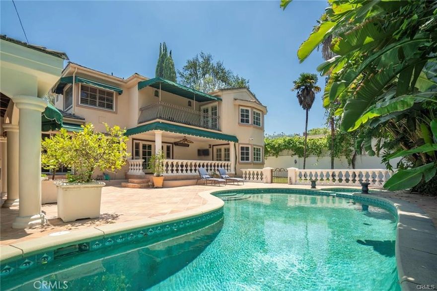 Furnished or Unfurnished!! Situated in a coveted South of Ventura location, this 4BR+5BA gated Mediterranean offers timeless elegance, perfectly suited for both everyday living and grand entertaining. From the moment you enter, the dramatic living room makes a statement with two-story beamed ceilings, skylights, and a striking fireplace. The formal dining room is ideal for hosting gatherings, featuring custom built-in cabinetry that adds character and functionality. A true showpiece, the gourmet kitchen was meticulously designed by a celebrity chef with entertaining in mind—complete with granite countertops, stainless steel appliances, a Viking six-burner stove with griddle and double oven, center island, custom cabinetry and a greenhouse window. The kitchen flows into a sunlit breakfast area and spacious family room with fireplace, built-in bar and wine cooler, all seamlessly opening to the stunning backyard. The main level features two ensuite bedrooms —including a generous secondary master suite with double sinks and french doors leading out to the yard. Upstairs, the primary suite is a true sanctuary. Enter through double doors to find a spacious haven with high ceilings, french doors, and a private balcony. The luxurious master bath offers double sinks, a spa tub, and an oversized shower, along with a dressing area featuring two vanities, an extra sink, and a huge walk-in closet. Step into the backyard and be transported to a private tropical paradise. Surrounded by lush foliage, the outdoor space is ideal for entertaining, with a resort-style pool and spa, covered patio, grassy yard and a cabana dining area. The outdoor chef's kitchen includes a built-in BBQ, two burners, deep fryer, sink, and a separate bar area- perfect for al-fresco gatherings. Set in a quiet section of Benedict Canyon Dr on a dead end street - not the busy stretch off Mulholland to Beverly Hills - this elegant Mediterranean retreat exudes a lifestyle of inspired living.