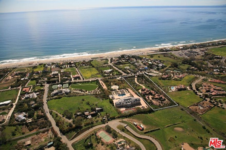 Incredibly Rare Building Opportunity on 5+ Acres of Ocean View Land. Discover the epitome of coastal luxury living with this exceptional 5.35-acre property positioned atop a scenic ocean-view knoll in highly coveted Malibu Park, overlooking legendary Broad and Zuma Beach. This extraordinary offering features approved architectural plans with permits already issued for a magnificently designed 7-bedroom, 10-bathroom classical estate, tastefully re-imagined by famed architect Clive Dawson to maximize breathtaking ocean, coastline and mountain views, while honoring the original estate lost to the Woolsey Fire of 2018. The approved plans call for a special exception granting 12,215 sqft of living space to be built, along with additional approvals for garages (979 sqft), and multiple covered terraces (1,254 sqft), all bringing the total measurement of the proposed new construction to 14,448 sqft. Truly a generational opportunity, this fire-rebuilding-exception offers the ultimate indoor-outdoor living experience with existing approval for maximum allowable living space. Experience unparalleled privacy and exclusivity while being just moments away from the vibrant amenities of Malibu and its famed beach culture. Wake up to inspiring views of the vast Pacific Ocean and savor intimate sunsets from multiple vantage points throughout the property. Embrace a luxurious lifestyle with top-tier amenities including a resort-like pool for relaxation and entertainment, a tennis court for staying active in style, along with abundant fertile land to cultivate your own organic farm-to-table lifestyle . This exceptionally rare offering presents a unique opportunity to build a bespoke estate in one of Malibu's most sought-after neighborhoods. Whether you envision a private retreat, an entertainer's paradise, or a luxurious family compound, this property sets the stage for unmatched coastal living.