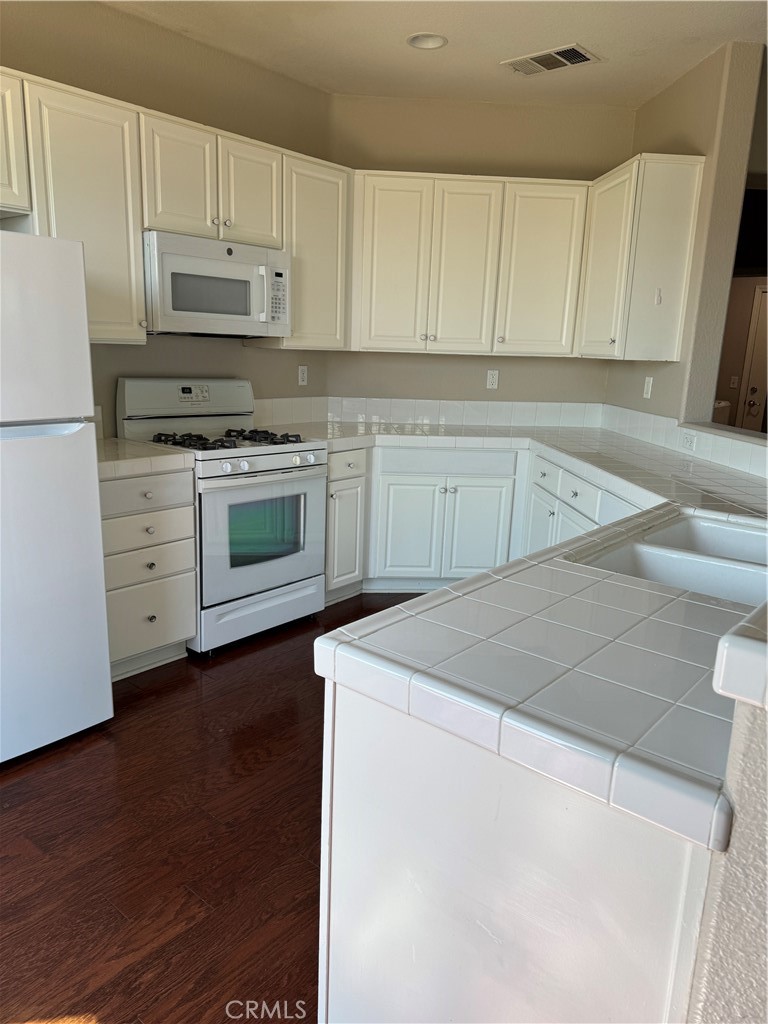 Please notice as you step inside, this home has fresh interior paint plus a new washer and dryer, Microwave and Refrigerator. New carpeting upstairs. Plantation shutters on all windows. Wood flooring downstairs. Fireplace in the living room. Private back yard with a view. Direct entry to home from a 2-car side by side garage. It has an HOA with a pool, spa, tennis court, club house, playground, basketball court, and a lake. This home has just been remodeled, and it shows in all the details. It is located near the 5 freeway and is close to schools and shopping. Please note homeowner will pay for the Gardner and the HOA Fees. Tenant to pay for all utilities.