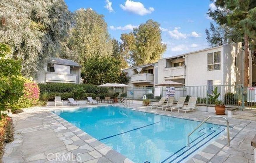 COME AND GET IT! Top level condo freshly painted. HUGE living room with vaulted ceilings! Updated kitchen with wood cabinetry, granite counter tops, and stainless steel appliances. Newer laminated floors throughout. Slider that leads to a balcony. Large primary bedroom with wall to wall mirrored closet doors. Private community offers gated entry, swimming pool and three spa areas, lush landscaping, community laundry, elevator access to unit level, and assigned tandem parking spaces.