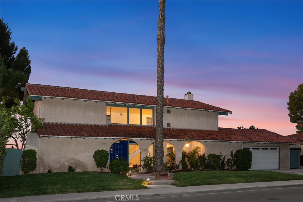 Welcome to this spectacular, Spanish Style, VIEW home with 4-bedrooms and 3-baths situated in the highly sought-after Woodland Crest neighborhood of Woodland Hills. From the moment you arrive, the slate-covered front porch and beautifully landscaped dry creek bed create an inviting and picturesque curb appeal. Step through double doors into a dramatic two-story entryway, where walls of glass immediately draw your eyes to sweeping, unobstructed forever views (backs Conservancy land). Indoor elegance meets the breathtaking beauty of nature in perfect harmony. Designed for both intimate living and grand entertaining, this home has been the backdrop for countless cherished memories. At the heart of the home is a fully renovated chef’s kitchen that impresses with every detail. Outfitted with top-of-the-line Jenn-Air appliances—including a 6-burner range with griddle and a beverage refrigerator—it features custom cabinetry, Quartzite waterfall countertops, a tumbled tile backsplash, a breakfast bar, and a cozy dining nook. The expansive family room is a warm, welcoming retreat with built-ins and a striking stone fireplace with a raised hearth. Upstairs, the private primary suite offers soaring vaulted ceilings, generous closet space, and a beautifully updated en-suite bath with dual vanities. Step onto your private balcony to savor peaceful sunrises and sunsets over the city and mountain skyline. Each secondary bedroom is spacious and light-filled, complete with ceiling fans and mirrored wardrobes. Two-story windows bathe the home in natural light, creating a bright, airy ambiance throughout. Step outside into an entertainer’s paradise: a covered patio, sparkling pool, putting green, and mature citrus trees (including lime and grapefruit) await. The massive Trex deck offers the perfect setting for unforgettable gatherings with panoramic views as your backdrop. Newer roof & windows, freshly painted and meticulously maintained, this home is truly move-in ready. Located just minutes from luxury shopping, approx. 15 minutes from Malibu, and near top-rated schools, this is more than just a home—it’s a lifestyle. With the new Los Angeles Rams training facility and the Warner Center 2035 Plan on the horizon, Woodland Hills is an area poised for exciting growth and opportunity. Don’t miss your chance to own a piece of Southern California paradise—where timeless style, unmatched views, and modern convenience come together seamlessly.
