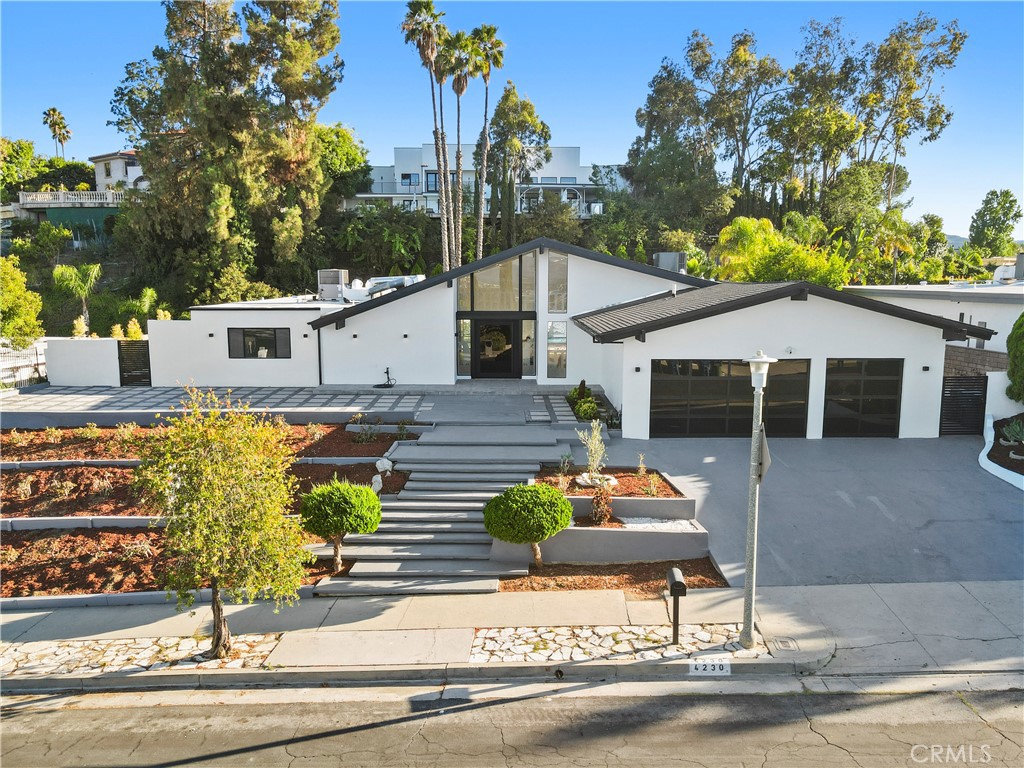 Welcome to this meticulously renovated home, located in one of the most sought-after neighborhoods in Encino. Designed to meet the demands of today’s lifestyle, this home seamlessly blends elegance, comfort, and modern luxury.
With a spacious open floor plan, this home offers an abundance of natural light, creating an inviting and airy atmosphere. The 18-foot high ceilings and recessed lighting elevate the design, while the seamless flow between indoor and outdoor spaces makes it perfect for entertaining or relaxation.
The chef-inspired kitchen is a true masterpiece, featuring custom-built cabinets, sleek black diamond leathered countertops, and high-end stainless steel appliances. Whether preparing a family meal or hosting guests, this kitchen is built for both style and function.
The outdoor space is equally impressive, offering a private oasis with a pool, spa and multiple seating areas, ideal for unwinding or enjoying family gatherings. The primary suite is a luxurious haven, providing ample space, privacy, and comfort, with an atmosphere of serene sophistication.
This home is more than just a property—it's a lifestyle. Offering a rare combination of timeless design, top-tier finishes, and an ideal location in one of Encino’s most prestigious Lake Encino community, this is truly a one-of-a-kind opportunity.