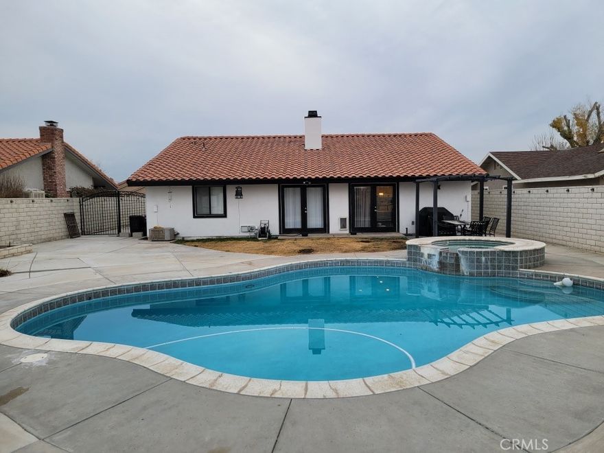 Discover this beautifully upgraded single-story pool home in the sought-after Spring Valley Lake community. This inviting three-bedroom residence boasts an open-concept kitchen, spacious living room, and a dedicated dining area. The kitchen is a chef’s delight with a generous island, heated wood-look ceramic floors, and a four-burner gas stove. The main suite features two distinct seating areas and a walk-in closet with stylish barn doors. Two sliding doors open directly to the expansive pool and spa area, perfect for entertaining. Additional bedrooms are generously sized, and the laundry room is conveniently located indoors. The gated backyard provides abundant space for outdoor activities, and is large enough for an ADU, RV, or boat parking. Located close to top-rated schools and shopping, this home offers comfort, convenience, and unique amenities.  Close to schools and shopping.