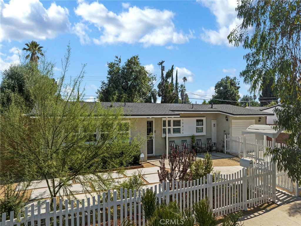 Come Fall in Love! Welcome to this Reseda gem, brimming with character, charm, and pride of ownership. Lovingly maintained, this spacious single-story home offers nearly 1,800 sq. ft. of living space on a 7,527 sq. ft. lot with 3 bedrooms and 2 bathrooms (plus a bonus utility bathroom in the garage). Inside, you’ll be greeted by gorgeous Saltillo tile floors in the main living areas and wood-look tile in the bedrooms. The bright, open-concept layout features vaulted ceilings, creating a light and airy atmosphere perfect for both entertaining and everyday living. The remodeled kitchen is a showstopper, complete with custom shaker-style cabinetry, quartz countertops, subway tile backsplash, and stainless steel appliances—ready for your inner chef. A spacious indoor laundry room offers abundant storage and convenience.
Step outside to your own entertainer’s paradise. A spacious covered patio with ceiling fans and outdoor lighting sets the stage for unforgettable gatherings. The large side yard offers plenty of storage space, plus a built-in outdoor storage closet. The garage is fully equipped with custom shelving and workspace. This home truly has it all—style, functionality, and room to live your best life.