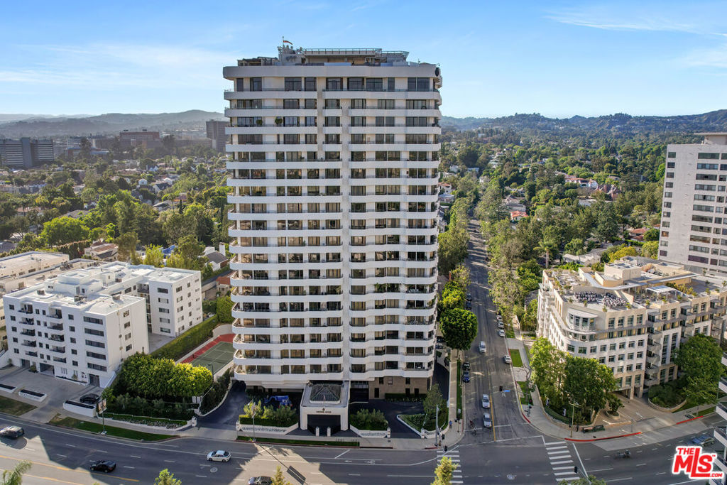 With its premier placement on the Wilshire Corridor, this single level unit in the Wilshire House is the perfect blend of prestige and contemporary style. Designed by internationally acclaimed Bauhaus architect Victor Gruen, the Wilshire House is Los Angeles' foremost luxury high-rise. The building boasts a wealth of amenities to enjoy, including a professional fitness facility, tennis court, pool, sun deck, library, meeting rooms, doorman, valet parking, and 24/7 concierge and security.Situated on the coveted Wilshire Corridor, you'll be mere minutes away from world class dining, shopping, and entertainment in Beverly Hills, Century City, Bel Air, and Westwood. Directly from the elevator, you'll enter your personal and secure lobby, which welcomes you into this fully custom 3 bed 5 bath unit. Proceed into the expansive living, family, and dining rooms where you'll find automated doors to separate or conjoin the space, and floor to ceiling windows that provide unobstructed city, mountain, and ocean views. Step outside and take in the sights, then soak up the breathtaking sunsets on the wraparound terraces and balconies. Make your way back inside to the gorgeous kitchen, which is equipped with beautiful granite countertops, a spacious island, two pantries and ample storage. From the kitchen, you'll have access to the intimate wet bar, card room and separate breakfast area. Pass through the hallway while strolling to the Primary Suite, where you'll find extensive custom built-ins, perfect for the art aficionado or collector. The primary suite, complete with dual walk-in closets as well as dual en-suite sumptuous bathrooms, featuring a separate steam and sauna will be your own personal haven of grandeur and comfort. The remaining two bedrooms are spacious, inviting, and picturesque, each offering additional stunning views. With this unit, you'll be able to enjoy the best that the Wilshire Corridor has to offer, all while being able to retreat to your private penthouse sanctuary. For a chic and opulent home, this is one you can't miss!