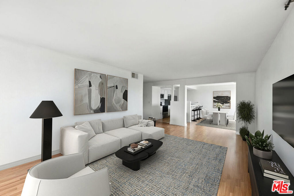 Welcome to this renovated, southwest-facing top-floor corner penthouse at 911 N Kings Rd the largest and most exceptional unit in the building! Featuring dramatic design, 8-foot floor-to-ceiling windows, and sweeping treetop views, this rare home is filled with natural light while offering privacy and tranquility.The spacious living/dining area is anchored by a gas fireplace with single-button turn on and opens to a balcony overlooking the hills above Sunset. The remodeled kitchen boasts updated countertops, cabinets, and recessed lighting with seamless flow for entertaining. Both bedrooms are generously sized with remodeled baths and ample storage.Building upgrades include CCTV security cameras, reinforced perimeter doors/locks, and a high-tech video telecom buzzer at the entrance. HOA also offers Wifi & satelite cable TV. Residents also enjoy two side-by-side garage spaces and resort-style amenities: pool, gym with sauna, and recreation room with pool table.All this with some of the lowest HOA dues in West Hollywood, and just moments from Melrose, Santa Monica Blvd, and the best of WeHo living. Don't miss this rare penthouse opportunity!