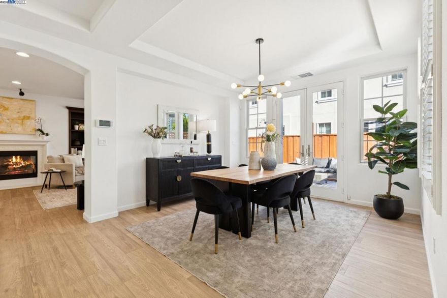 First time on the MLS! The original owners have taken meticulous care of their beloved home of 18 years. Located on a quiet cul-de-sac in Alameda’s sought-after Bayport community, 5 Cornelius Square offers an ideal blend of space, style, and function. This Warmington Build Plan 7 features 2,806 sq ft with 4 bedrooms and 3 full baths, including a convenient main-level bedroom and bath. The open-concept kitchen boasts brand-new Taj Mahal quartz counters, a walk-in pantry, generous island, sunny eat-in area for casual dining, and a Wi-Fi–enabled smart refrigerator. The formal dining room opens through French doors to an oversized side yard—perfect for outdoor entertaining. The light-filled living room offers a gas fireplace, custom built-in cabinetry, and surround sound. Freshly painted interiors, new waterproof laminate flooring, soaring ceilings, and abundant windows enhance the bright, airy feel. Upstairs, discover a spacious loft, 3 additional bedrooms, and a laundry room with upgraded smart washer and dryer. Dual-zoned A/C provides year-round comfort. With an oversized 4640 sq ft lot, a two-car garage, and prime location minutes to the SF Bay Ferry, Alameda Landing, parks, and schools—this home feels like new, modern yet timeless.