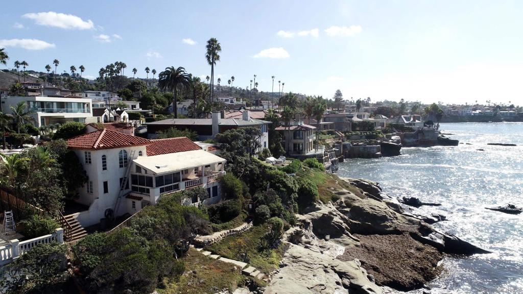 La Casa De Los Amigos~Behind the gates of this magnificent direct Oceanfront Estate, you'll unlock nearly a century of history. The architecture which is reminiscent of Old Hollywood/meets Casablanca, will intrigue your imagination w/possibilities. Located on the glistening coastline of La Jolla, you'll enjoy panoramic ocean views with steps that lead directly to the water. This property has a very rare oceanfront presence, w/access to the sand on low tide. Hear the crashing waves from your very special indoor/outdoor spaces. The entry courtyard is extremely private and is the heart of the home. There is an abundance of potential to bring this treasure back to its original glory. Main home composed of 4 bedrooms & 4.5 baths,w/ an additional detached Bedroom & full bath over the garage.