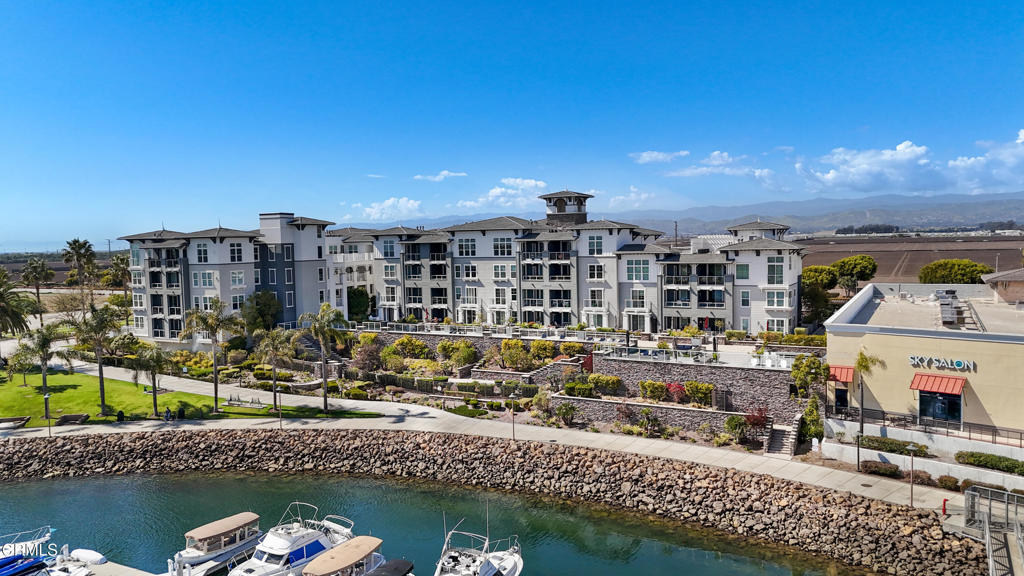 Welcome to one of the most rare and desirable homes in Seabridge's 'Port Marluna' community. One of only six exclusive first-floor condos with an extra-large south-facing patio offering stunning channel views, plus a second shaded, north-facing patio that provides a quiet escape from the elements. Whether you're soaking up the sun or enjoying a peaceful afternoon in the shade, this home gives you the best of both worlds.This 2-bedroom, 2-bathroom, 1,700 sq/ft condo is in the Enclave at Seabridge, one of the newest buildings in the harbor, built in 2017. Inside, you'll find hardwood floors throughout, including both bedrooms and closets, and elegant wood shutters in the kitchen and office. Thoughtful upgrades include a Murphy bed, Nest thermostat, new dishwasher (2024), water softener, and reverse osmosis system.The double-gated subterranean garage includes EV charging, with one parking space that has a storage cage already installed, and HOA approval for an additional cage if desired.The Seabridge lifestyle is unmatched. Enjoy 24/7 guard-gated security, a heated pool and spa, state-of-the-art fitness center, and an absolutely stunning clubhouse, perfect for entertaining, with high-end finishes, indoor/outdoor seating, BBQ areas, and space to host large parties while enjoying harbor views. You'll also find beautiful public walking trails, pet-friendly greenbelts, and scenic marina paths perfect for morning strolls or sunset walks.Just outside your door are a variety of restaurants, cafes, shops, gyms, and salons, making this location incredibly convenient whether you're going out or staying in. The Seabridge community is about 50% second homes, giving it a resort-like, peaceful atmosphere that feels like a private slice of paradise.