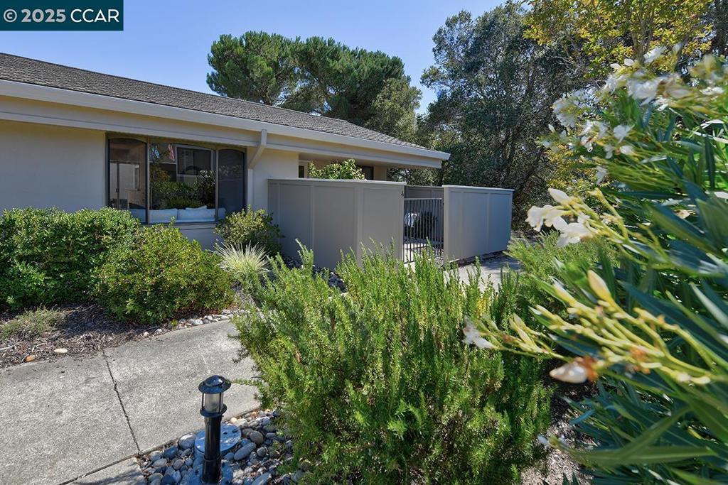 Darling, end unit San Franciscan model, tucked away in a quiet setting. This is a highly desirable model that is level-in with nobody above or below. Enjoy the peaceful outdoors from the privacy of the fenced in front patio or the interior atrium. All new vinyl plank flooring and fresh interior paint. Stacked washer/dryer in bathroom. There is a serene wooded setting directly to the side of this property. An owner could apply for a Rossmoor permit to replace the wood fencing to a wrought iron fence to take advantage of the view from the patio. Carport is close by with an lots of extra built in storage. This home is move in ready with tons of potential!