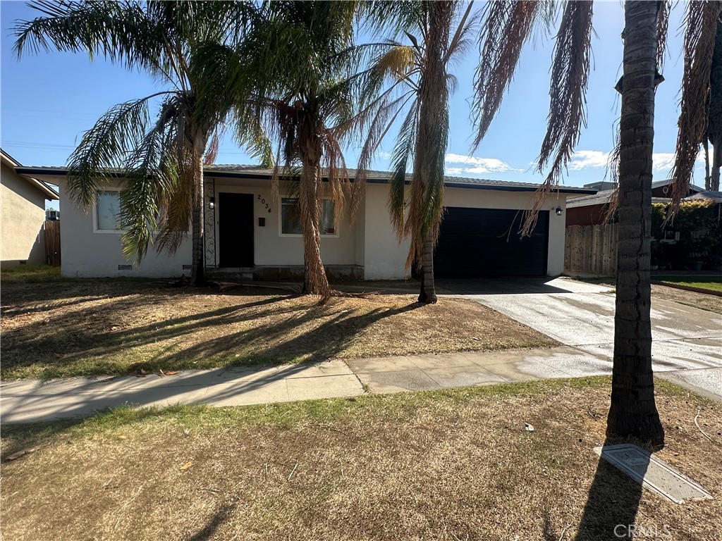 Remarkable value for this detached FOUR bedroom single family home with 1.5 baths and an attached two car garage! This home has a modern twist with its creamy white exterior and dark trim, white vinyl windows and gray shingle roof. The front yard has several palm trees, and the backyard has plenty of room for entertaining or a supersized playset. The interior has fresh paint,and a combination of warm hued tile and hardwood floors. The kitchen is neat and clean with white cabinets, granite counters, a newer cooktop, and built-in dishwasher and wall oven. Don't delay!