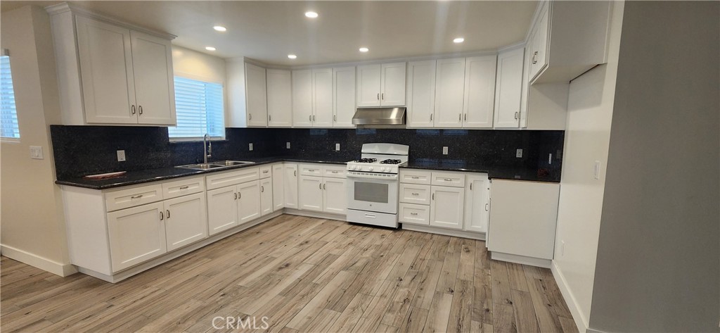 Now available is a new build apartment with a large living space and a kitchen that's every chef's dream. This apartment is the lower unit of a 2 unit ADU that includes 1 car garage parking with EV charging. The unit is partially subterranenan and has an L shaped living room, dining area, and kitchen with an abundance of lighting. The kitchen has wall to wall cabinets and ample counter space. The primary bedroom suite has a large en-suite bathroom with a large vanity and automatic lights. Both bedrooms have good natural lighting and large closets. The hall bathroom mirrors the primary bathroom with a large vanity, automatic lights and tub/shower combo.