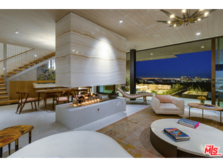 Amazing price adjustment on a rare 2.8 acre promontory, City of Beverly Hills home. A Marmol Radziner designed compound circa 2013 this home combines art with provocative materials, a seldom found collaboration. The interior spaces are intimate and flow seamlessly to the loggias, pool and city beyond. The master suite occupies the entire upper floor and is surrounded by eco-friendly roof top gardens and jetliner city to ocean views. Additional bedroom suites, office, library, media room and guest quarters allow for flexible use of the space. The bold exterior basks in western sunsets surrounded by organic and drought tolerant landscapes. Also featured are a saltwater infinity pool and spa, Savant automation, solar power system and three car garage. **Renderings shown are potential property enhancements.