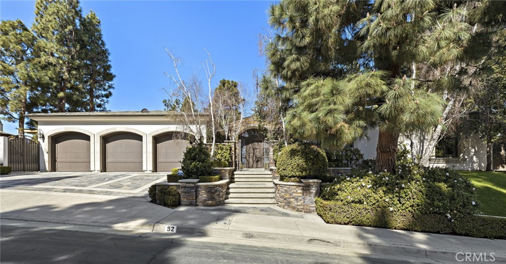 Rare find! An exquisite single-level custom home with sky views in the prestigious guard-gated Big Canyon community of Newport Beach. This elegant residence, which was rebuilt in 2002, offers privacy and serene views, ideal for sophisticated living and entertaining. Perfectly appointed with traditional design, a gated flagstone entry and water features lead to custom double entry door with beveled glass. Inside, the formal living room features cavernous ceilings, French doors, a marble fireplace, and a sunken wet bar. The dining room boasts silk walls, custom wine storage, and cove lighting, with access to a private patio with a soothing fountain. The chef's kitchen is equipped with granite counters, a large island, and premium high-end appliances, opening to an informal living space with a stone fireplace and additional dining area. A private office with cherry cabinetry provides a refined workspace. The primary suite includes a luxurious bath with marble floors, a spa tub, and dual customized walk-in closets. Additional generously-sized bedrooms offer en suite baths and walk-in closets. The private yard features an outdoor kitchen, fireplace, fountain and flagstone patio. Additional amenities include limestone floors, volume ceilings, laundry room, air conditioning, and 3-car garage. This home has an enviable location on a quiet single-loaded street. Discover luxury living in the exclusive Big Canyon guard gated community, one of the finest golf clubs in the world and minutes from Fashion Island and the Pacific Ocean.