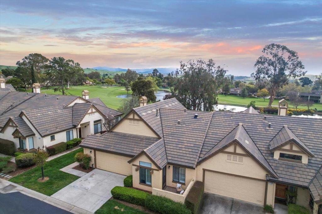 This wonderful home located in The Villages (Age 55+) is the epitome of Resort-Style living with a rare prime location backing the lush green golf course with views of numerous ponds, scenic mountains, blooming flowers, and gorgeous sunsets! The Villages is the place to thrive, a true hidden gem of an oasis in Silicon Valley, featuring a premiere golf course, social activities, clubs, bistro, pickle ball, tennis, swimming and more! This lovely home is a dream home with the perfect floor plan designed to capture views through the wall of windows in the living room and dining room. The expansive patio off of the living room and dining room is perfect for indoor outdoor entertaining. The living room features a cozy fireplace open to the dining room with high ceilings. The updated granite slab kitchen has a sunny nook, ample cabinets for storage, and expansive counter prep space. The oversized primary suite features a vaulted ceiling, walk in closet, a private patio and a large updated bath with double sinks and an oversized shower. The second bedroom has a convenient Murphy bed for guests and a built in matching desk. The window seat overlooking the golf course is a relaxing place to read and enjoy the view. This is a cherished home in the most serene of settings.