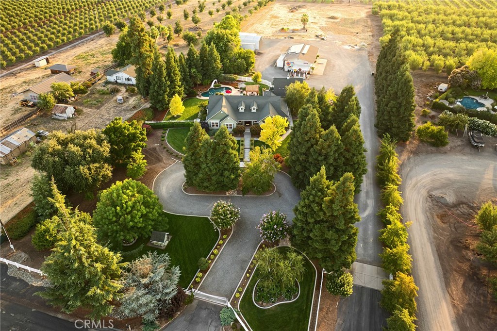 You'll have to see it to believe it! This unique and one of a kind property offers country living at its finest. Rare 4 acre parcel amongst Chico's famous orchards. In addition to the custom home, there is a guest suite above the garage, an incredible 3 bay 1,920 SF shop, owned solar panel system, pool, garden, chicken coop, RV parking, storage for equipment, plus room to expand! There is even space to build a second home on the back half of the property. The home features were planned with comfort in mind. Chef's kitchen, formal dining room, spacious living room and tasteful primary bedroom suite. High ceilings throughout, crown molding, wainscoting, and coffered ceilings are just a few of the details included in the design. You can feel the quality of the craftsmanship. The backyard showcases a Pebble Tec pool with a water feature, baja bench and slide. The oversized two car garage provides extra storage space. The 76 Gas Station inspired decor on the 32' x 60' shop is a hobbyist's dream!! Many of the antiques and collectibles can be included with the sale. The electric lift makes working on vehicles a breeze. The shop is equipped with roll up doors, an office area, bathroom and wood burning stove. The walls are fully insulated to keep it warm in the winter and cool in the summer. The garden area is shaded and lined with box hedges. It is a perfect place to find some tranquility. Fruit trees include cherry, apricot, plum, apple and Meyer lemon. There is enough covered parking for all your toys and equipment. This property truly has it all...!