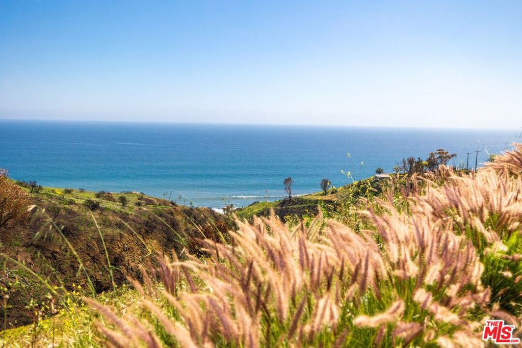 This 1.26-acre 1993 burn lot comes with plans for a 6,371 sq ft custom plans featuring 4 bedrooms, 4.5 bathrooms, an infinity pool, indoor sauna, and a three-car garage. Thoughtfully designed to follow the natural topography, the home captures unobstructed, south-facing views of the Pacific Ocean and Catalina Island.Located on Eagle Pass Drive a quiet cul-de-sac once home to around 10 properties before the 2025 Palisade Fire this is a rare chance to build a luxury retreat in one of Malibu's most scenic and close-knit canyon communities, just minutes from the PCH.
