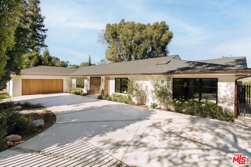 Nestled in the hills of Studio City, this gated modern European-style home exudes timeless elegance and contemporary charm with unobstructed views of the valley. Spanning 3,515 square feet, the open-concept layout seamlessly blends spacious living areas, creating an ideal flow for both entertaining and everyday living. The home features five generously sized bedrooms and 4.5 luxurious bathrooms, each appointed with natural stone finishes that complement the home's sophisticated design. The smooth stucco exterior is complemented by sleek brass gutters, creating a striking contrast with the neutral tones and modern lines of the architecture. Inside, European white oak hardwood floors run throughout, bringing warmth and texture to every room. The combination of natural stone finishes and a soft color palette adds to the home's sense of refined simplicity, while large windows flood the interiors with light, offering views of the surrounding greenery. This residence offers the perfect balance of modern luxury and European-inspired design. Additional features include built in speakers, tankless water heater, all new plumbing and electrical, pebble tec finished pool, outdoor shower, lutron light system, circular driveway and all new hardscape/landscape. This is one you won't want to miss!