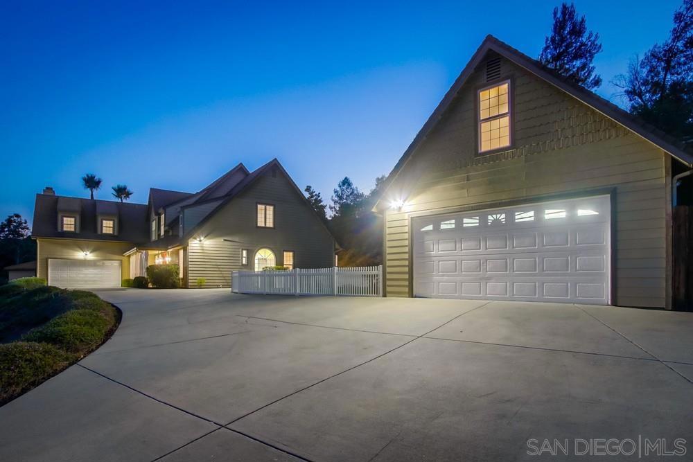 Where space, serenity, & style collide—this Fallbrook estate delivers it all. Set on 2.4+ manicured acres with panoramic views, horse corral, multiple flat + usable tiers, all just steps away from the 15th tee box of Pala Mesa Golf Course. A long, meandering driveway leads to the main residence perched proudly above it all. Quiet, peaceful, & private—yet just 5 minutes to freeway access. Inside, a true 5 bed, 3.5 bath floor plan drenched in natural light with vaulted ceilings and multiple living spaces anchored by a dramatic dual-sided fireplace. The oversized first-floor primary suite features a designer bathroom w/ dual vanities, free-standing tub, walk-in tile shower, & massive walk-in closet. The Chef’s kitchen stuns with quartz counters, SS appliances, full pantry, and island bar seating. Upstairs: 4 bedrooms (some w/ secret hidden spaces) + 2 baths, including a 420 sq. ft. flex room perfect for in-laws, play, or game room. Attached to the main home is an oversized 2-car garage, & detached is a completely separate 2-car garage/workshop w/ a 585 sq. ft. air-conditioned “man cave” that sits above. The outdoor space is perfect for entertaining: pavers, pergola, wood-burning fireplace, hang-out lounge, large fenced grassy area, horse shoe pit on the top tier, & other manicured spaces. Other features include: Luxury vinyl plank floors, dual-zone HVAC, new railings, 17 panel solar, fire sprinklers, recently serviced septic system, & a full sized laundry room. Need a separate space? Pick a tier and add up to a 1,200 sq. ft. ADU -- feasibility study already complete.