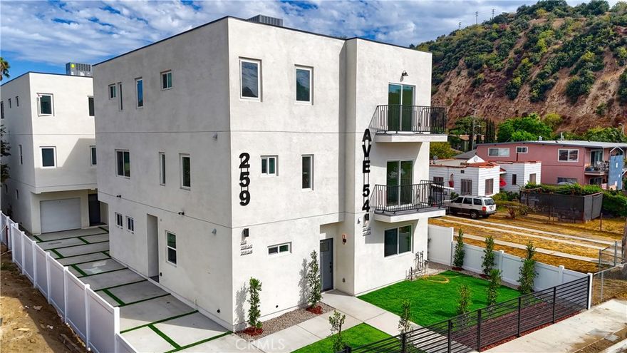 Brand New Construction in Highland Park! Welcome to 259 and 259 1/2 Avenue 54, a modern 4-bedroom, 4-bathroom tri-level townhouse that blends designer finishes with thoughtful functionality. The first floor offers a private bedroom with full bath and walk-in closet, perfect for guests or a home office. The second level features a bright open-concept layout with soaring ceilings, white oak cabinetry, quartz countertops, custom railings, and a full brand-new stainless steel appliance package including refrigerator, range, dishwasher, and microwave. Natural light pours into the spacious kitchen, dining, and living areas, which extend to a private balcony with hillside views. A second bedroom and full bathroom complete this level. The top floor offers two bedrooms with en-suite bathrooms, plus a laundry room with washer and dryer included. This home showcases white oak flooring throughout, spa-inspired bathrooms with premium tile, recessed lighting, and modern black hardware. Additional features include energy-efficient solar panels, EV charging capability, central A/C and heat, and secured parking. Be the first to live in this newly built residence designed for today's lifestyle. Ideally located in the heart of Highland Park, you'll be just steps from York Boulevard's boutiques, coffee shops, and nightlife, and half a mile from Figueroa Street's acclaimed restaurants and entertainment. Only one mile to the Metro Gold Line for easy access to Downtown LA and Pasadena, 10 minutes to Occidental College, 15 minutes to Dodger Stadium, and 20 minutes to the Arts District. With modern finishes, hillside views, energy-saving upgrades, and a prime location, this move-in ready home is the best of Highland Park living. Enjoy local favorites like Highland Park Bowl, Kitchen Mouse, Café de Leche, and Hippo, all just minutes from your front door.