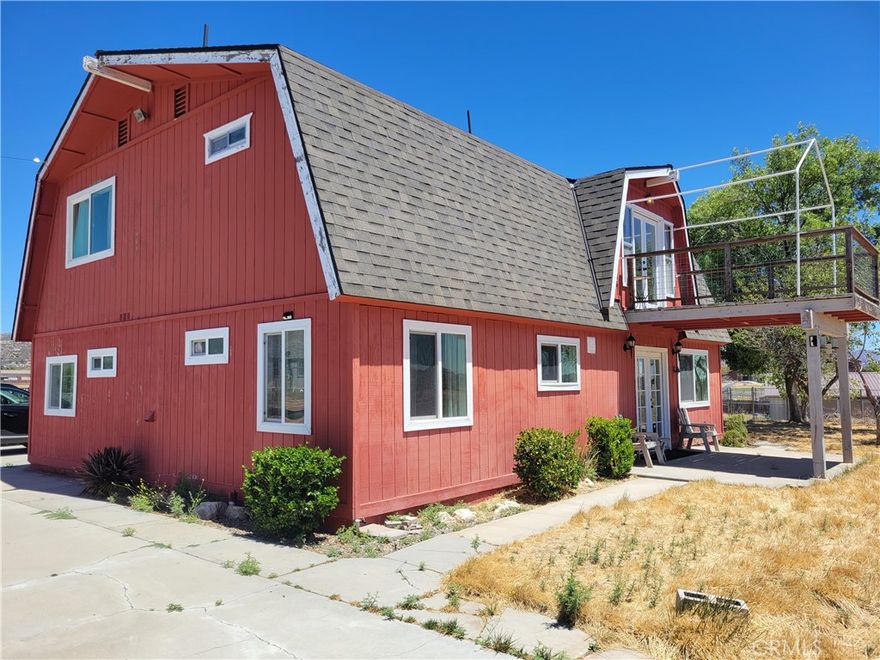 Charming Two-Story Home on Usable Horse Property with Barn, Workshop & More.  Paved Road for easy access!! This two-story home features three spacious bedrooms, each with its own private bathroom. A convenient downstairs bedroom is located just off the great room—ideal for guests or multi-generational living. The home boasts a large galley-style kitchen with solid surface countertops, perfect for both daily living and entertaining. Just off the kitchen, you’ll find a laundry room equipped with washer and dryer, plus access to a pantry for added storage, as well as a convenient half bath.  Upstairs, the primary bedroom suite offers a peaceful retreat with double doors leading to a private balcony—a perfect vantage point to enjoy sunrises, sunsets, and starry nights.  A spacious two-car garage provides ample room for vehicles and workshop area with loft storage space above.  The property also features a large barn with four stalls and an enclosed area that includes two rooms, a kitchenette, and a bathroom—ideal as a home office or retreat.  The home and garage have a brand NEW ROOF.  Sitting on gently sloping, fully fenced and cross-fenced acreage, this property is well-suited for horses, livestock, or a variety of agricultural ventures such as orchards, vineyards, or hobby farming. Mature trees provide shade and seasonal fruit from existing pomegranate, pear and apple trees.   A wrought iron gate welcomes you to the property, leading up a sweeping concrete driveway with ample paved parking near the home and garage.This is a rare opportunity to own a well-appointed home on land that offers space, functionality, and flexibility—ideal for equestrian, agricultural, or country living dreams.
