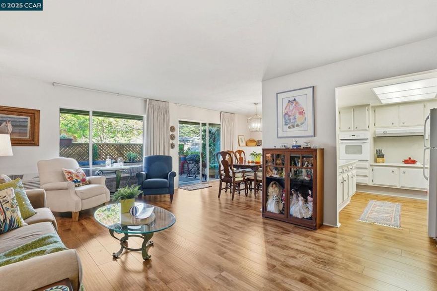 Avoid the high costs of upgrades. Turnkey Perfection.  Charming Kentfield Home with Custom Updates and Serene Surroundings. Nestled in a welcoming community with walkable access to a nearby park and majestic redwood trees, this beautifully updated Kentfield model offers the perfect blend of comfort, style, and convenience. The spacious floor plan is enhanced by luxury vinyl plank flooring throughout—durable, easy to maintain, and ideal for everyday living. The versatile living and dining "ell" area features custom built-in cabinetry with five deep storage compartments, a lift-out desk, and an integrated electrical charging station—perfect for work-from-home flexibility.  Cheery kitchen boasts sleek stone counters & splash-backs, a smooth-top range, and thoughtfully designed pull-out shelves for maximum functionality. The bathroom is a true retreat, showcasing a large walk-in shower with rain glass doors and dual sidelites, a modern vessel sink atop a stone vanity, closeted Bosch washer/dryer. Additional highlights include Window shutters in the bedrooms for privacy and charm. Ground-level patio with lattice privacy screens for outdoor relaxation. Smooth ceilings and updated lighting for a fresh, contemporary feel. Keyless entry installed. Just move-in and live.