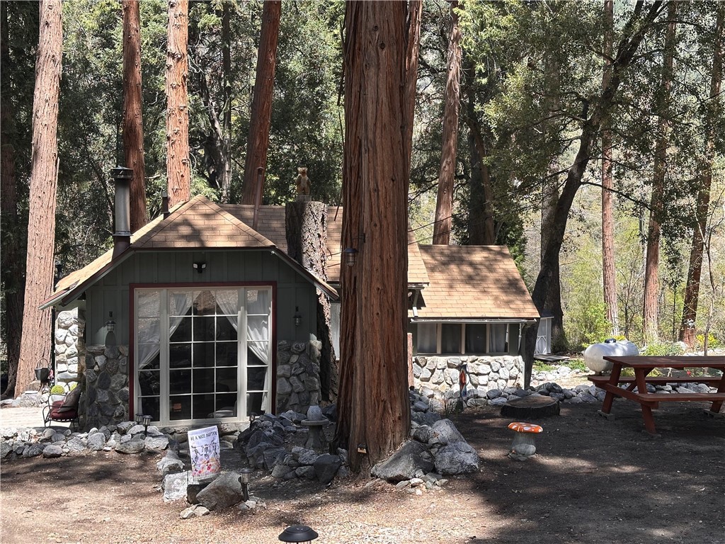 Escape to nature with this cozy two-bedroom, two-bathroom cabin nestled in the heart of Forest Falls, just 25 miles east of Redlands off scenic Highway 38. Surrounded by towering trees and natural beauty, this mountain retreat is just a short stroll from the local general store and restaurant, offering both convenience and seclusion.
Inside, you’ll find a spacious living and dining area perfect for relaxing or entertaining. The full kitchen includes a cozy breakfast nook, ideal for enjoying a morning coffee while taking in the forest views. Both bathroom feature a stand-up shower for added comfort.
Step outside to explore the charm of Forest Falls, complete with a picturesque creek, breathtaking waterfall, and an abundance of local wildlife. The property also includes a detached 400 sq. ft. garage—ideal for storage, a workshop, or potential additional use.
Whether you're looking for a peaceful weekend getaway, a seasonal escape, or an income-generating rental, this mountain cabin is a perfect fit. Don’t miss your chance to own a slice of forest paradise!