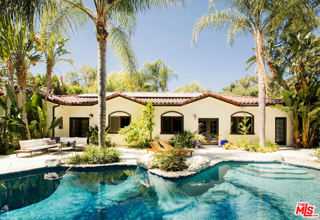 Discover this gated Mediterranean residence nestled in Pasadena's prestigious Linda Vista neighborhood. Situated on a spacious, flat lot, the property boasts a grand front lawn and lush tropical landscaping that create a welcoming, resort-like ambiance. Step into the broad formal entryway that sets the tone upon arrival. By combining two of the bedrooms, a true primary retreat that has been created, now offering en-suite living room. Its luxurious spa-inspired bathroom features radiant heated floors, a soaking tub, and a glass shower. The chef's kitchen is outfitted with Viking appliances, an oversized refrigerator, and a walk-in pantry, perfect for entertaining. Modern upgrades include a 12.4 kW solar array with Tesla Powerwall, EV charging station, Yale smart locks, Nest Protect system, and a Waterdrop reverse-osmosis in kitchen, filtration system servicing the entire home. Enjoy outdoor living at its finest with a saltwater, resort-style pool and spa, complemented by different areas for dining, grilling, and lounging beneath mature palms. Just minutes from the Rose Bowl, Old Town Pasadena, and JPL.