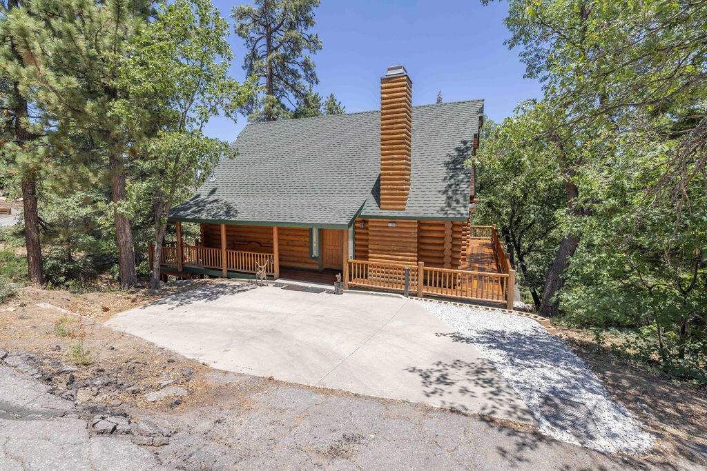 Charming Real Log Cabin with Ski Slope Views! Nestled on a spacious lot near the National Forest, this authentic log cabin offers the perfect blend of rustic charm and modern comfort. Just a short distance to Bear Mountain Ski Resort, the golf course, and scenic hiking and biking trails, this location is ideal for year-round mountain living. The main house features 3 bedrooms and 2 bathrooms, plus a bonus bedroom and bath with a separate entrance below the main living area--perfect for guests or potential rental income. The large primary suite boasts vaulted ceilings and treetop views, while the loft/game room provides additional living or entertaining space. Enjoy ski slope and forest views from the freshly painted decks and relax in the inviting outdoor living space surrounded by mountain air and tall pines. Inside, you'll find a gas fireplace, an indoor laundry area, and plenty of natural wood finishes throughout. Furnishings and contents are negotiable, making this a turnkey opportunity whether you're looking for a primary residence, vacation home, or income-producing rental. Don't miss this rare opportunity to own a true mountain retreat in an unbeatable location!