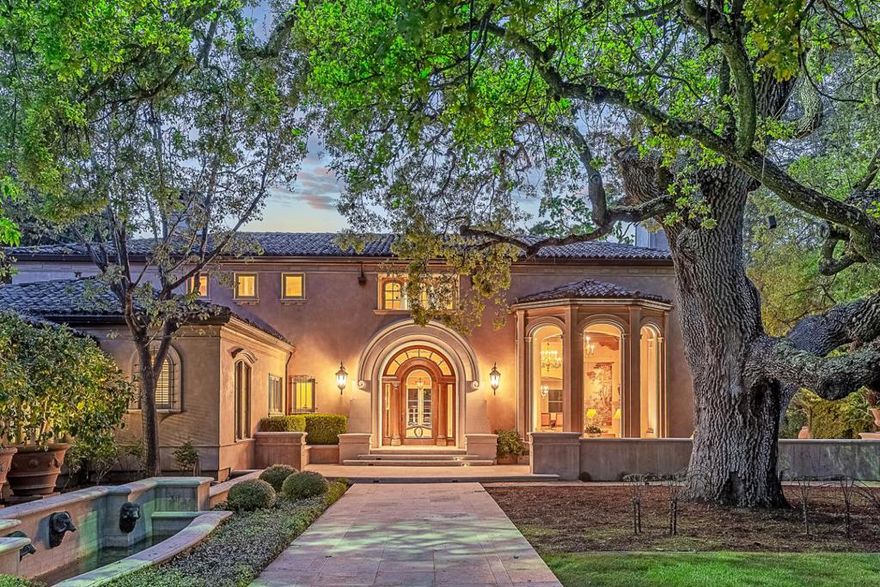 In the heart of central Atherton, this extraordinary estate is a masterpiece of design & craftsmanship, offering a rare combination of grandeur, privacy, & resort-like amenities on 2.5 acres. Every space is designed to impress, with soaring ceilings, expansive windows, & a seamless flow that enhances both formal entertaining & everyday living. There are grand public rooms alongside more intimate spaces, ensuring both sophistication & comfort. Chef's kitchen is complemented by a large butler's pantry & a sommelier-worthy wine cellar. There are five sumptuous bedroom suites, each with spa-inspired baths & serene views, including a multi-room primary suite. There are also two offices plus a separate two-bedroom, 1-bath guest house with full kitchen for extended family or guests. Surrounded by a setting of absolute beauty, the grounds unfold with manicured gardens, sculptural fountains, & meandering walkways leading to a pool & spa, tennis court, & a secluded waterways garden hidden beyond centuries-old-style walls. A spacious cabana takes center stage for outdoor entertaining, offering the perfect venue for gatherings of any scale. Enveloped in privacy and embraced by natural beauty, this is a truly iconic estate in one of the most prestigious locations in the country.