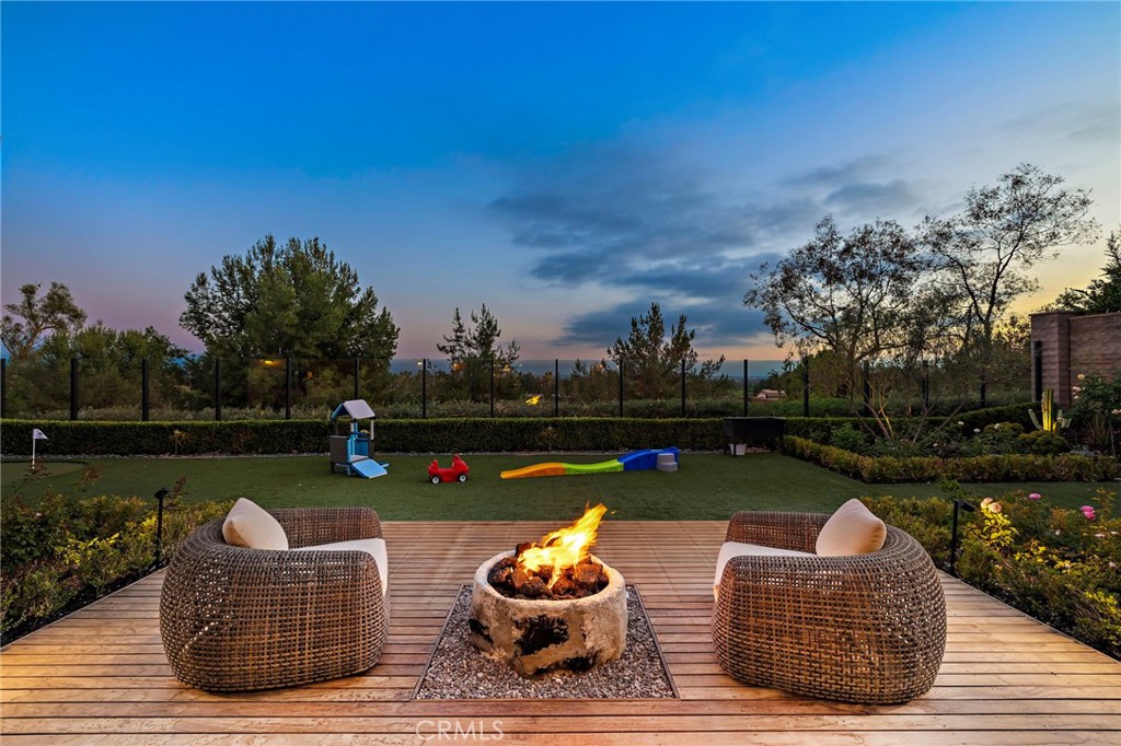 Welcome to 137 Sunset Cove, Irvine — an exceptionally rare offering on one of the most sought-after, view-facing streets in all of Irvine. No homes have come on the market on Sunset Cove with this kind of view and lot size in over two years — making this a truly unique opportunity. Sitting on an oversized premium lot of over 10,000 square feet, this estate is a rare gem, especially within a guard-gated community where large parcels are nearly impossible to find at this price range. Every inch of the home and yard has been meticulously upgraded with high-end finishes, from thoughtfully designed landscaping to luxurious indoor enhancements — blending beauty, comfort, and functionality. The California room has been fully enclosed with permits, transforming it into a year-round indoor living space that enhances flexibility and usable square footage. The primary suite is conveniently located on the first floor, featuring direct access to the backyard through large sliding glass doors. Imagine waking up in bed to the tranquil, tree-lined views beyond your private glass fence — it’s the perfect retreat. Inside, the home offers a modern open-concept layout with soaring ceilings, designer lighting, and spacious living areas. The chef’s kitchen is the heart of the home, equipped with top-of-the-line stainless steel appliances, an oversized waterfall island, and elegant custom cabinetry, ideal for everyday luxury and entertaining. Additional highlights include: • A rare Italian-inspired front and middle courtyard with a staircase that leads directly to the second-floor loft — both practical and architecturally distinctive. • A shared circular driveway with neighboring homes, offering both enhanced curb appeal and an extra-spacious front yard perfect for children’s play or additional outdoor living. • A generous three-car garage and rare layout of two bedrooms on each floor. Enjoy a low-density community with abundant orchards and mature landscaping, award-winning Irvine schools, low HOA dues, and remarkably low cost of ownership. Located near Irvine Spectrum, Woodbury Town Center, top dining, parks, and with easy access to major freeways and beaches, this home offers the very best of luxury and convenience. Don’t miss this rare opportunity to own a landmark home in one of Irvine’s most prestigious communities. Schedule your private tour today and experience luxury living redefined.