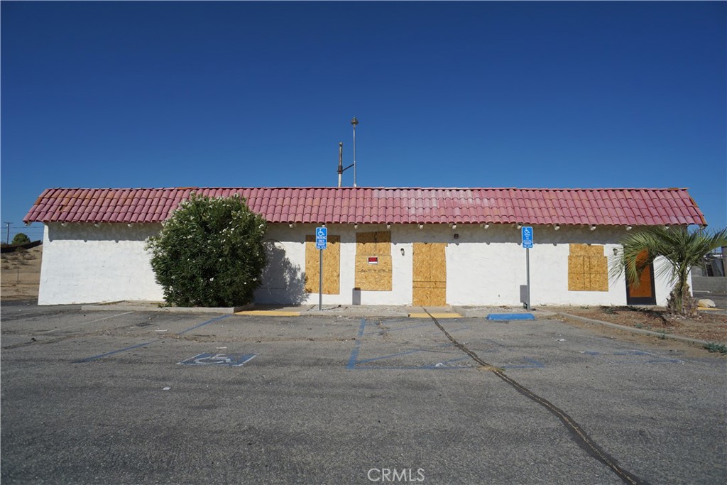 FOR SALE. This single-story, mixed-use property at 15623 Village Drive, Victorville, CA 92394 offers approximately 3,892 sqft of floor area on a 0.66 acre (28,924 sqft) lot with 38 paved parking spaces. Built in 1977, the building was used for several past uses including a restaurant and church use under C-1 zoning. The interior layout includes entrance, offices, bathrooms, back rooms and a large open area. The property needs work and renovation after damage done from a fire. Given the extent of damage is unclear, buyers should rely on their own due diligence for structural evaluations and updated interior/exterior photos before moving forward.
As the largest commercial hub between San Bernardino and the Nevada border, Victorville has been experiencing accelerating economic and population growth. The city’s population is projected at 141,700 for 2025, up approximately 5.2% since 2020, and growing at roughly 1% annually, in line with trends for the broader Victor Valley metro area, which is nearing 608,000 residents.
A burst of logistics, retail and hospitality investment has driven southern California developers and national tenants northward to the city. In late 2023, Victorville landed three major warehouse projects totaling around 4 million sqft, including new regional distribution facilities for Amazon and Goodyear. Even with fire damage this location enjoys exceptional visibility, and traffic counts directly off the I-15 Mojave Drive exit and sits at the epicenter of millions of square feet of new industrial construction and fast-emerging retail corridors. With the high parking count, existing land use, and zoning flexibility (church, retail, commissary/restaurant, flex industrial, or office) any buyer will benefit with the wave of build-to-suit redevelopment under way in Victorville, leveraging the foundation and location to secure long-term investment with logistics or service operators from regional demand ($6M+ new projects, fast-food, medical, commuter services). Seller open to all offers. Sold as-is. Buyer to verify all.