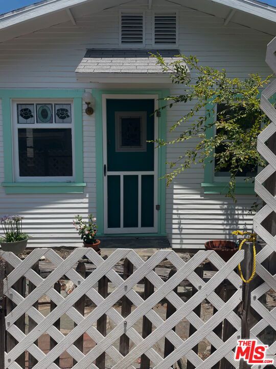 Discover a slice of California history in this enchanting 1917 beach cottage, nestled in a quiet pocket of Redondo Beach just blocks from the ocean. This rare, standalone home blends vintage charm with modern updates, offering both warmth and functionality in a compact, character-rich package. Step inside to original architectural detail, warm natural light, and vintage stained glass windows that add timeless artistry to the space. The cozy interior includes one bedroom, one updated bathroom with a walk-in shower, and a refreshed kitchen with new cabinetry and countertops. Thoughtfully maintained, the home retains its original soul while offering essential upgrades for comfortable everyday living. What sets this cottage apart is its private outdoor space, with an estimated 600 square feet of exclusive-use yard wrapping two sides of the property. Perfect for lounging, container gardening, morning coffee, or evening wine. Gated and lined with lattice for added privacy, it's a rare find in this coastal neighborhood. Approximately 450 square feet inside, this detached one-bedroom, one-bath cottage sits just blocks from the beach, shops, and cafes. Available now. Shown by appointment. Call Owner Directly - Text Agent for contact info.