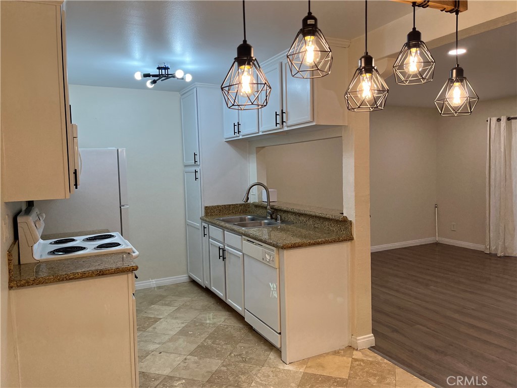 This beautifully upgraded ground-level condo features: two spacious bedrooms, a stylishly remodeled bathroom, and durable laminated wood flooring. Step outside to your private outdoor patio and enjoy a prime location, offering easy access to both the driving and pedestrian gates.
Perfect for first-time buyers, downsizers, or investors, this affordable home is ready for immediate move-in. No restriction on renting the condo as an investment property, and pets are allowed.
The affordable HOA provides an abundance of amenities, including: two assigned parking spaces,
Two swimming pools and a spa,
Six barbecue areas for gatherings,
a fitness center, a yoga room, and a community laundry facility with 24 washers and dryers.
Clubhouse with a full kitchen, sitting area with electric fireplace, game room with pool table, card table, and TV—ideal for entertaining friends and family.
This FHA-approved complex also offers convenient access to the 110 Freeway, local restaurants, and shopping centers.
Don’t let this opportunity pass you by to move into the very affordable, highly sought-after community of Pacific Pines.