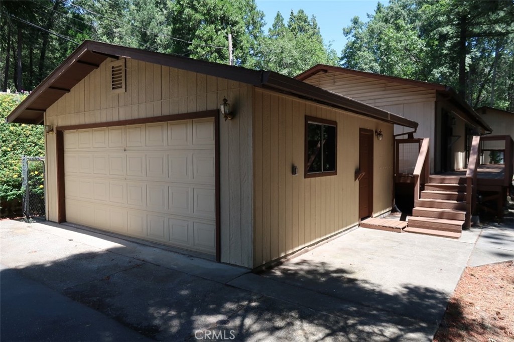 Welcome to your peaceful retreat in the beautiful Paradise Pines neighborhood! This roomy 2-bedroom, 2.5-bath manufactured home sits on a generous .55-acre lot—one of the largest in the community—offering plenty of space and privacy.
You’ll love the convenience of two paved driveways: one leading to the front of the home and another to the detached 2-car garage, complete with a handy half bath, workbench, and extra storage for all your tools and hobbies.
Step inside to find thoughtful updates throughout: a newer central furnace (2020), updated septic system (2020), newer dishwasher, and attractive vinyl plank flooring in the kitchen, laundry area, and bathrooms. The bedrooms, living room, and family room feature fresh, plush carpet installed in 2022 for extra comfort.
The layout offers an open feel with a spacious kitchen and dining area that flows into the cozy family room and an extra-large living room warmed by a wood stove—perfect for gathering on cooler evenings. Stay comfortable in every season with multiple newer wall A/C units.
One of the best spots to unwind is the large composite back deck, which wraps around the breezeway between the home and garage and can be accessed from the living room, family room, or primary suite. This outdoor space overlooks the open backyard with terraced landings, mature trees, an extra shed, and plenty of room to add a garden or your own personal touch.
As part of the Paradise Pines HOA, you’ll also enjoy great amenities like a clubhouse, pool and spa, tennis courts, playground, bocce ball court, and more. Plus, you’re close to shopping, dining, lakes, and all the recreation that makes living on the ridge so special.
Don’t miss this chance to own a spacious, updated home on a rare oversized lot—come see it today and imagine the possibilities!