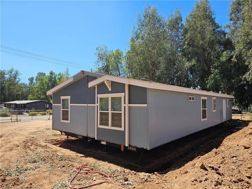Half acre lot. Open concept. Brand new 4 Bedroom 2 bath manufactured home in the County side of Lake Elsinore. Manufactured home is being put on a certified low profile permanent foundation. Easy to finance. Great location. All paved streets and close to stores and a few minutes from the 15 freeway and highway 74. Great for commuters. Lots of matured trees and plenty of space for your toys, a work shop, garage, etc. New everything (Septic system, AC, etc.). Never lived-in. Move-in ready.