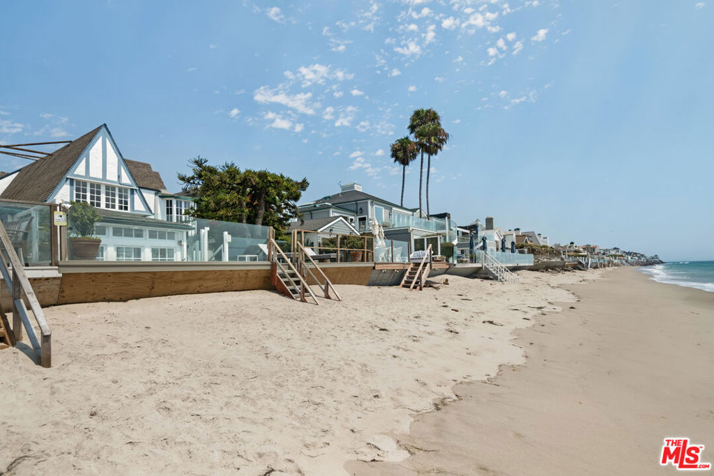 Historic Malibu Colony. This home, on 37.5 feet +/- of beach, is located in the sandiest section of The Colony. Built in 1928, and upgraded through the years, it remains a classic. Two-story beachside windows lead to a private patio adjacent to the tea house. Five bedrooms, four and one-half baths (which includes a complete, separate guest quarters with kitchenette), and an office. High ceilings, oversized brick fireplace, and an enchanting bougainvillea covered flagstone entryway. Still the charming, relaxed and comfortable beach home after almost 100 years.