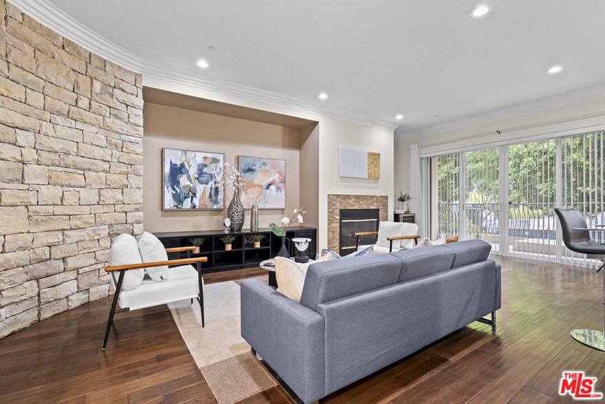 Experience the epitome of luxury living in this stunning 3 bed, 4 bath condo located in the prestigious Hancock Park neighborhood. With an expansive open floor plan and soaring ceilings, this residence offers the feel of a single-family home. The sunlit living room features a cozy fireplace and opens to one of three oversized balconies, perfect for indoor-outdoor entertaining. The gourmet kitchen is a dream come true for any chef, complete with custom cabinetry, professional-grade appliances, premium stone countertops, and a breakfast area with wet bar and wine cellar. All three bedrooms are generously sized with ample closet space, and each bathroom is elegantly designed with top-quality finishes. The serene primary suite includes a spa-like ensuite and walk-in closet. High-end hardwood and tile flooring run throughout the home, while a dedicated laundry room allows for side-by-side washer and dryer. This is the best location in the building bright, private, and beautifully maintained. Two side-by-side parking spaces and a private storage unit are included. The secure, gated community features lush landscaping, a fitness center, conference room, and outdoor area perfect for children or pets. Moments from Beverly Hills, West Hollywood, and Downtown LA. Don't miss this rare opportunity to own an elegant and move-in ready home in one of LA's most sought-after areas!