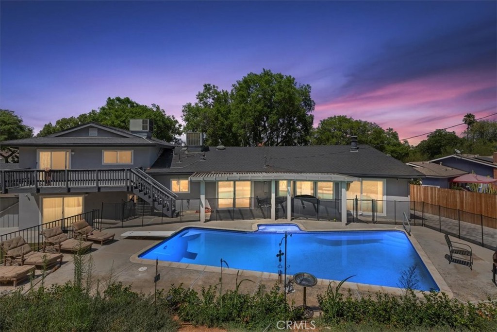 *Royal Hill Classic* Mid Century split level home in a popular neighborhood that is nestled on a quiet tree lined cul-de-sac. As you enter the original double doors you will find a beautiful slate floor entryway. The formal living room opens up to the dinning area and kitchen making a fabulous space for entertaining. There is a bright sun room off of the dinning area featuring a vaulted wood beam ceiling and new carpet. The kitchen was remodeled and has quartz counter tops with a stainless steel cooktop and vent. All of the windows and sliding glass doors were recently upgraded to energy efficient dual pane. Downstairs is complete with fourth bedroom, half bath and access to the backyard. Upstairs boats a spacious primary suite along with two additional bedrooms and second full bath. You will love the terrace located off of the bedroom with a stairway leading to your resort like backyard. The large rear yard is complete with a pool, spa, and patio cover. The garage appears to be a 3 car (with rear roll up door to additional parking pad), but has ample space that is currently used as a bonus room and gym that could become a 4 to 5 car garage or ADU. Huge lot, RV parking, low taxes, no HOA...this one checks all the boxes.