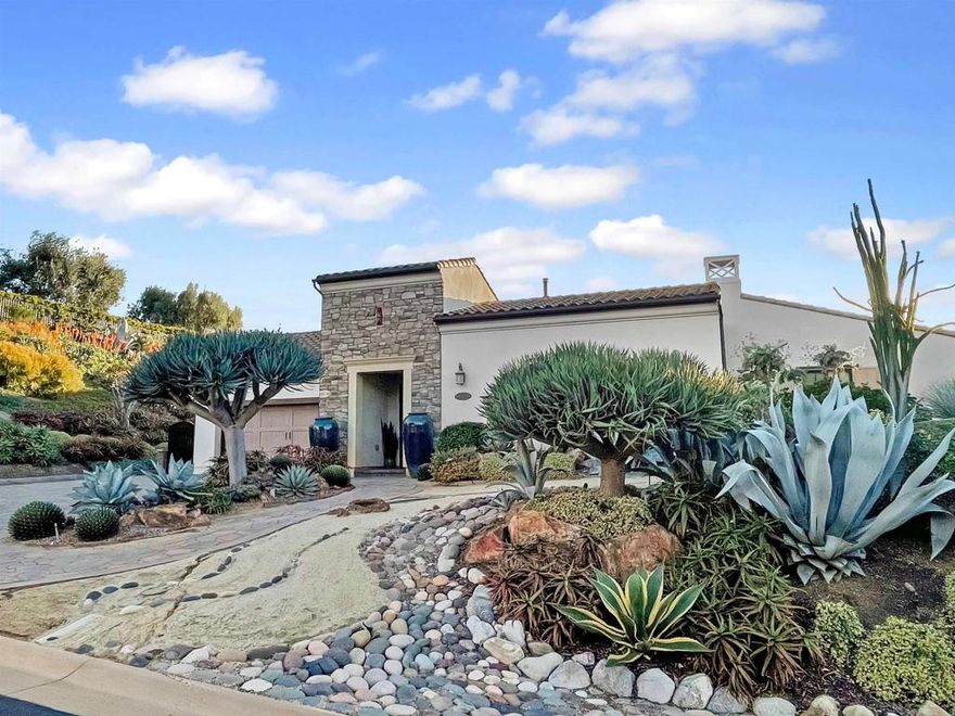 Indulge in luxury living within one of San Diego’s most sought-after gated communities. Located in The Lakes above Rancho Santa Fe, this single-level, 3,867 sq. ft. home sits on over half an acre with serene lake and canyon views. Set on a quiet cul-de-sac, this home features over $900,000 in thoughtfully curated upgrades and landscaping. Entering the house, a peaceful private courtyard welcomes you with a water fountain and shaded seating area.  It’s here that you have access to the attached casita featuring a bedroom, full bath, and walk-in closet.  Inside the main home, high ceilings and rich hardwood flooring create an impressive first impression. The chef’s kitchen includes white cabinetry, custom granite countertops and backsplash, Monogram appliances, a 6-burner gas range, dual ovens, a walk-in pantry, and a butler’s pantry with a wine fridge which opens to a spacious dining room that’s ideal for entertaining. The adjoining family room features built-in cabinetry, a cozy fireplace, and expansive sliding doors that open to the backyard and view vistas. The primary suite is a peaceful retreat with an en-suite bathroom offering dual sinks, a luxurious soaking tub, separate shower, and large walk-in closet. Additional spaces include a media room/office and a powder room with a seeded-glass window. All secondary bedrooms offer large en-suite bathrooms. The entire property, which has been featured in several books and magazines, has been thoughtfully designed by renowned, award-winning landscape designer Michael Buckner and includes many rare and unique plant specimens that provide a beautifully rich arrangement of colors and textures. The backyard is a true oasis and includes a covered California room which is perfect for dining, entertaining and enjoying true outdoor living. A striking water feature, an inviting fire feature, and peaceful views of the lake complete this beautiful outdoor retreat. Additional highlights of the home include fully owned solar, ensuring energy efficiency, a large 3-car garage with epoxy flooring and abundant storage space with built-in cabinets and two tankless water heaters. The Lakes community offers family-friendly living and is located within the highly rated, award-winning Poway Unified School District. The Crosby Club at Rancho Santa Fe is just down the street and acts as the social hub of the community where you can enjoy world-class golf, dining & entertainment, and fitness facilities that include pool, tennis, and pickleball. The home is conveniently located just 12 minutes from the Village in Rancho Santa Fe and a short drive to Del Mar and Solana Beach, providing easy access to the best of Southern California's lifestyle, including 25 golf courses, 17 parks, and 4 hiking reserves within 10 miles. With over 79 restaurants within 5 miles, the home is also conveniently located near the I-15 and CA-56 freeways.