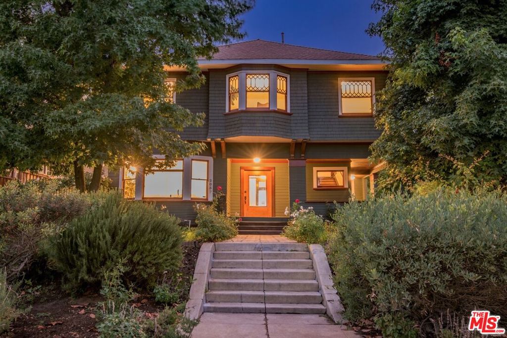 2057 S Oxford A Meticulously Restored Historic Craftsman in West Adams. Steeped in the architectural history of West Adams, 2057 S Oxford is a rare Craftsman that has been restored to the highest standard, preserving its historic integrity while elevating it for modern living. Subtle diamond-shaped details in the original windows a quiet nod to its rumored nickname, The House of Diamonds hint at the artistry woven throughout. Every detail reflects quality and care: original hardwood floors beautifully refinished, historic hardware and lighting thoughtfully polished and preserved, and all major systems plumbing, electrical, HVAC, roof, and foundation fully updated. The kitchen honors the home's character while delivering modern function with custom cabinetry, premium appliances, and sophisticated finishes. Upstairs, the primary suite offers a spacious, serene retreat with a decorative fireplace, generous closet space, and an en-suite bath finished in natural, earth-toned designer tile. The guest bath retains its original, beautifully restored clawfoot tub, and a stylishly remodeled powder room on the main floor adds convenience. Outdoors, artistic native landscaping features crawling jasmine, lavender, white roses, and a moody willow tree, creating a lush, inviting garden. A long gated driveway and large storage shed provide utility, while charming hidden stairs and Craftsman details add moments of discovery. A true piece of West Adams history restored to perfection while honoring its timeless charm.
