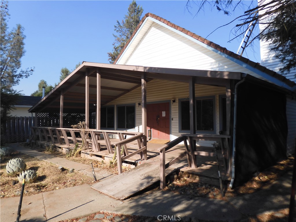 This is a custom build home built by the past owner. Flag lot that has it's own private driveway that sits back off the road. Main entrance is in the rear of the home. The home has a huge covered Patio to keep you cool on those warm summer days at the rear entrance. There are great views of the mountains and large camping area that owners can use. There is a huge living area. The wood work is somthing to be seen in the main living area. Open kitchen flows thru formal dining area and living area. Main bedroom is upstairs but don't worry 2 large bedrooms down stairs also. Wood burning stove in the living room. Property has 3 car garge parking. Main 2 car has large wood burning stove. There is a shop and 1 other covered parkig area. Needs updating but worth the time. Laundry is located on main floor. Property is located in beautiful Long Vally area. Very unique property worth a look.
