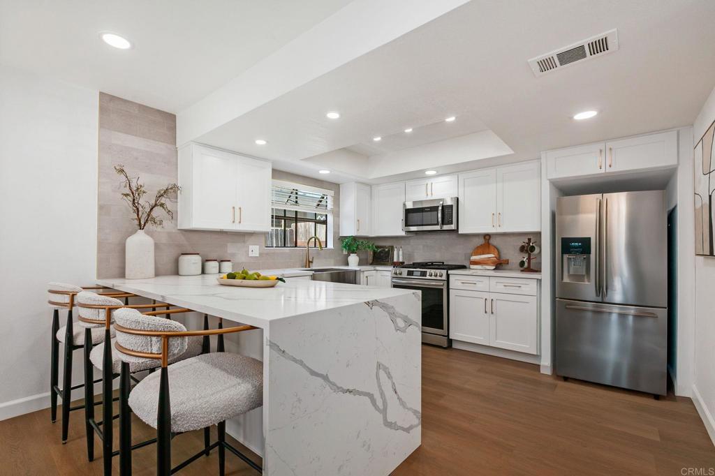 Live the best of Orange County living in this beautifully remodeled 2-bedroom, 2.5-bath home—designed as dual primary suites for ultimate comfort and privacy. This turnkey home blends modern elegance with a coveted location in a boutique 10-home community, Blue Horizon Villas, thoughtfully designed by renowned Newport Beach architect Brion Jeanette. Step inside to light-filled interiors where new luxury vinyl plank flooring and fresh designer paint flow seamlessly through the open floor plan. The living room’s striking tiled fireplace sets a stylish yet cozy tone, perfect for relaxing evenings. The chef-inspired kitchen features quartz countertops, chic white cabinetry, stainless steel farmhouse sink, and an open layout ideal for entertaining. Both bedrooms are full en-suites, each with a newly renovated bathroom featuring designer tile showers, sleek vanities, and— in the primary— a spacious double vanity for added ease and comfort. Perfectly positioned near the scenic Upper Newport Bayview Trail and The Ranch at Newport Bay Market Center, and minutes from Fashion Island, South Coast Plaza, UC Irvine, Orange Coast College, Hoag Hospital and John Wayne Airport. With low HOA, and a private, light-filled setting, this rare offering delivers the style, convenience, and exclusivity you’ve been looking for.
