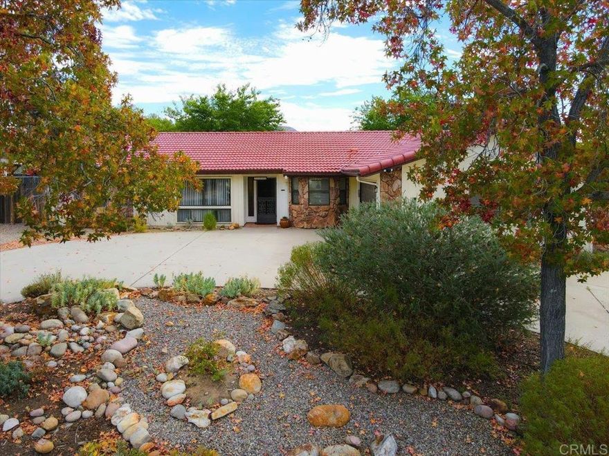 Beautifully updated 4-bedroom, 3-bath home on a half-acre of level, usable land with PAID SOLAR! Open great-room floor plan features wood-style vinyl flooring, brick fireplace, and plenty of natural light. The kitchen has granite counters and recessed lighting. The primary suite has an updated bathroom and direct access to the backyard.  Fully fenced backyard has huge shed and large covered patio for entertaining. Lush lawn, shade trees, garden area, plenty of room to play, and for horses or add your dream pool or ADU. Direct access to horse trails. Newer roof and HVAC. Low to nonexistent electric bills to save you $$$