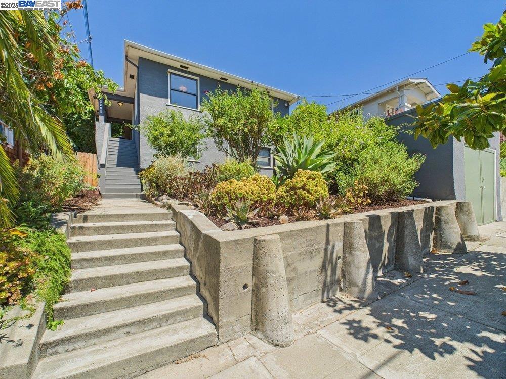 Welcome to 4418 Virginia Avenue, a rare and radiant Craftsman in Oakland’s beloved Maxwell Park. With 4 bedrooms, 2 full baths, and 1,583 square feet, this home offers the feel of a spacious suburban retreat while embracing its neighborhood roots. Beyond the drought-tolerant landscaping with fruit trees and native plantings, a serene, light-filled interior awaits. Inside, sun-splashed rooms, warm hardwood floors, and an effortless flow between living and dining areas set the stage for cozy evenings or vibrant entertaining. The kitchen features natural stone countertops, two-tone cabinetry, and a cheerful breakfast nook that opens directly to the backyard—creating a rare indoor-outdoor connection. Upstairs, a spacious primary suite offers treetop views, plush carpeting, and a full en suite bath—perfect as a retreat, home office, or guest sanctuary. Three additional bedrooms downstairs offer flexibility for family life or creative pursuits. Both bathrooms have been refreshed with modern vinyl tile and stylish fixtures. Out back, enjoy a multi-tiered yard with patio dining, garden beds, a hot tub zone, and room to grow. On a quiet street in a close-knit community, 4418 Virginia is minutes from cafés, commuter routes, and everything that makes Maxwell Park shine.